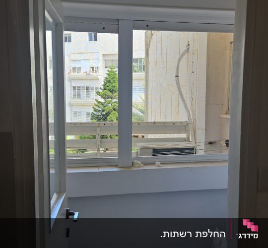חלון אלומיניום לבן עם רשת בחלון שירות